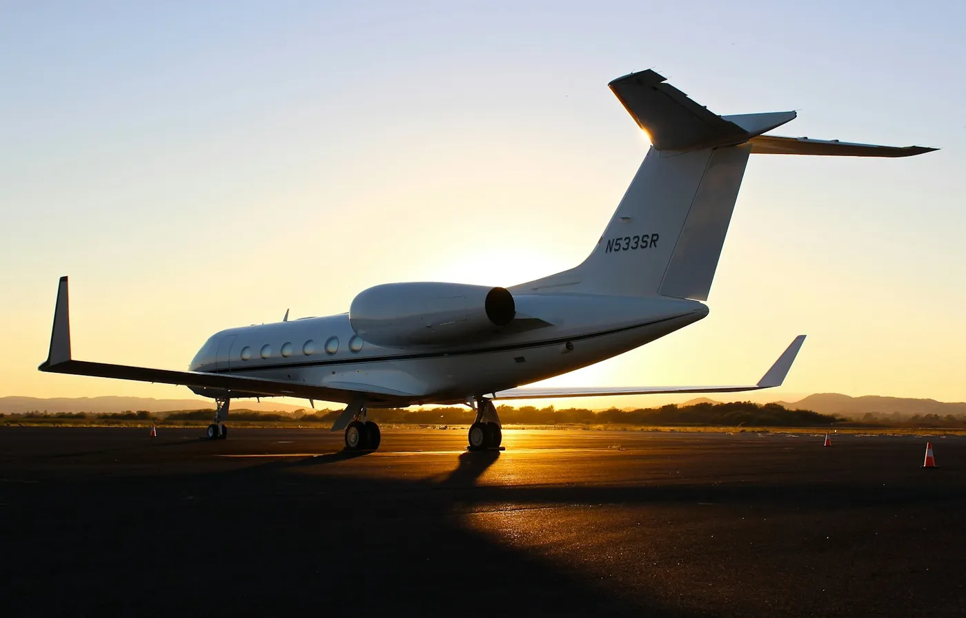 Stock photograph of an aircraft parked on an airport apron at sunset