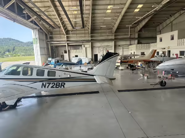 Cessna and other aircraft parked in the Hangar13 shop